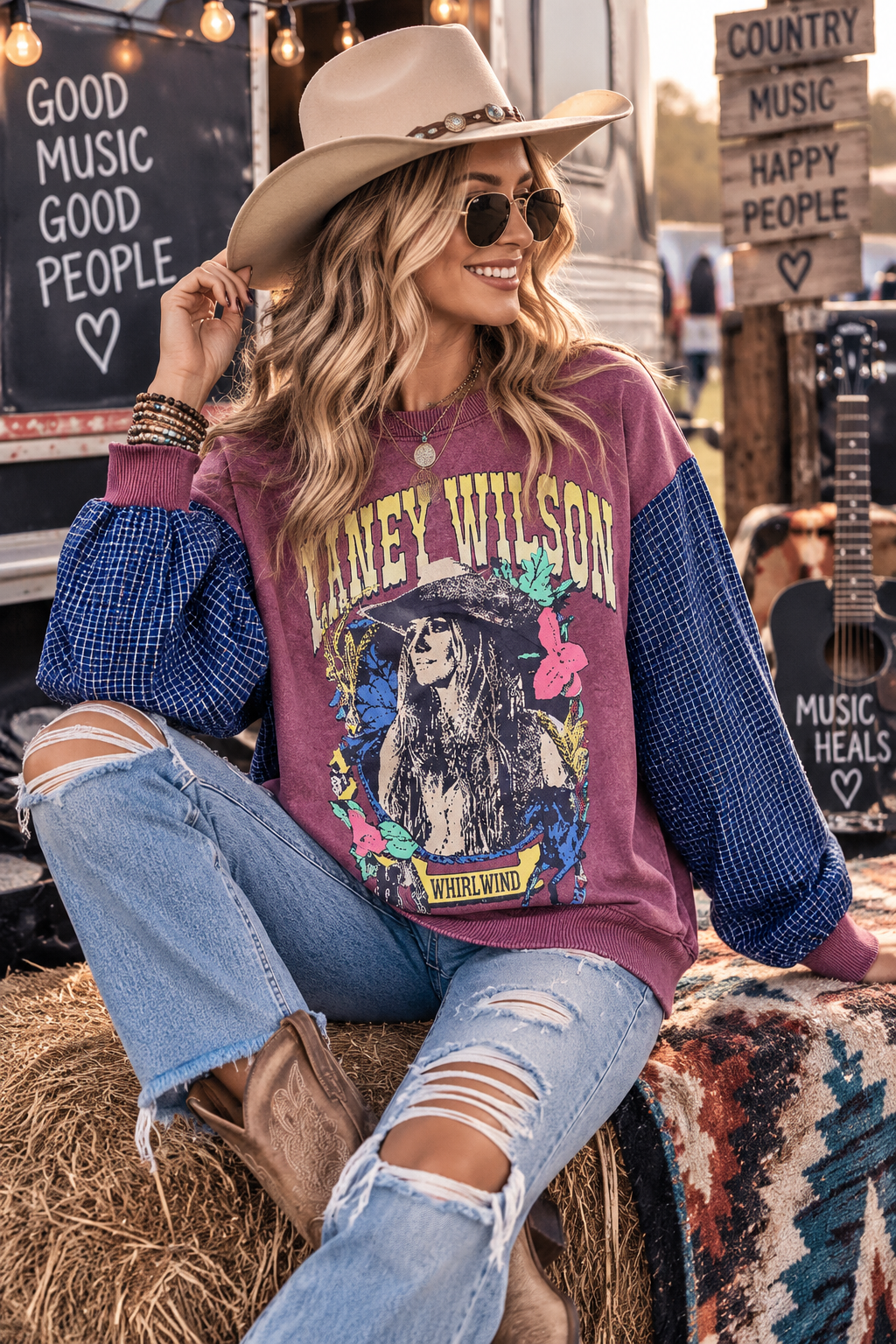 Model wearing upcycled Laney Wilson Whirlwind graphic sweatshirt with navy cotton plaid sleeves and ribbed cuffs, size 2X